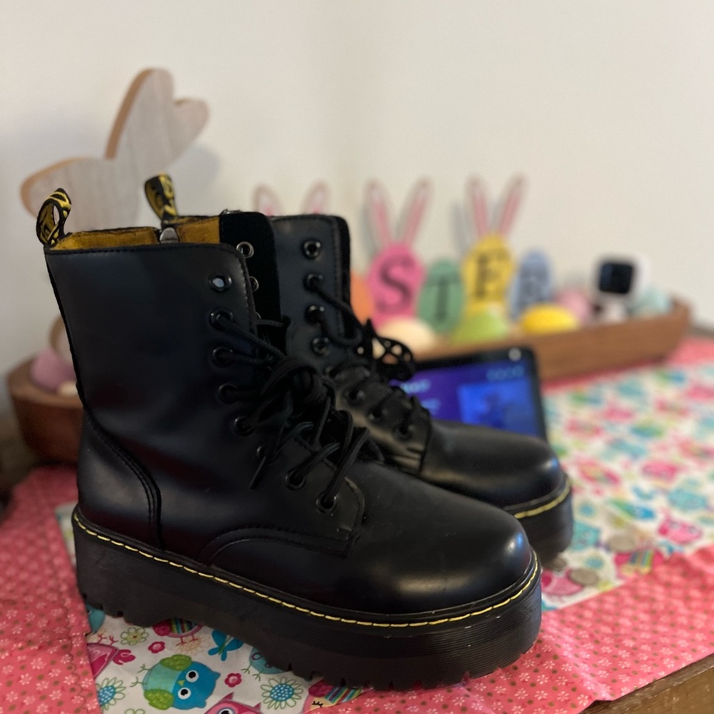 Black and yellow stitch boots